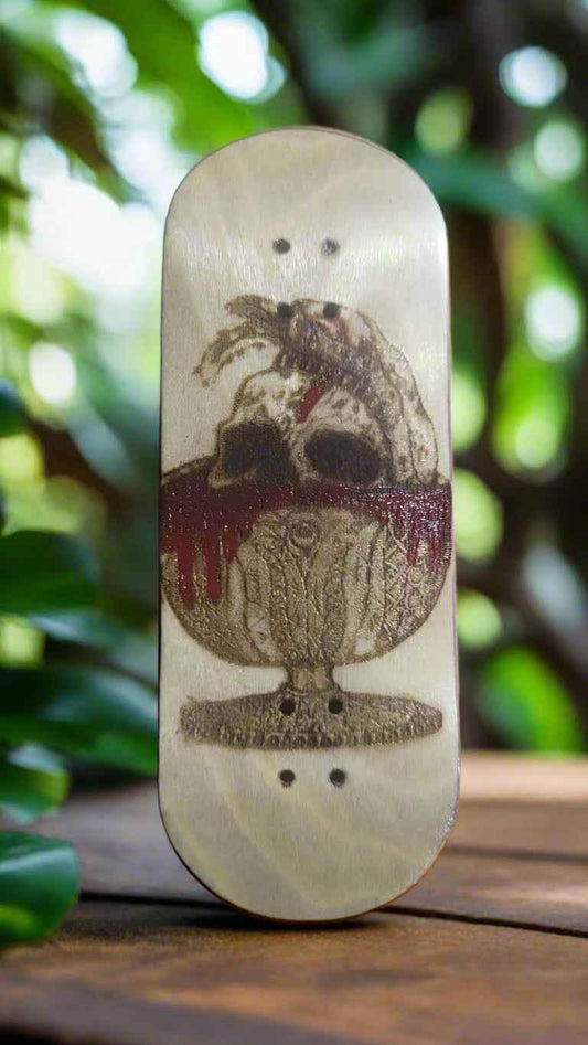 Handmade fingerboard deck featuring a skull and chalice graphic on a light wood surface.