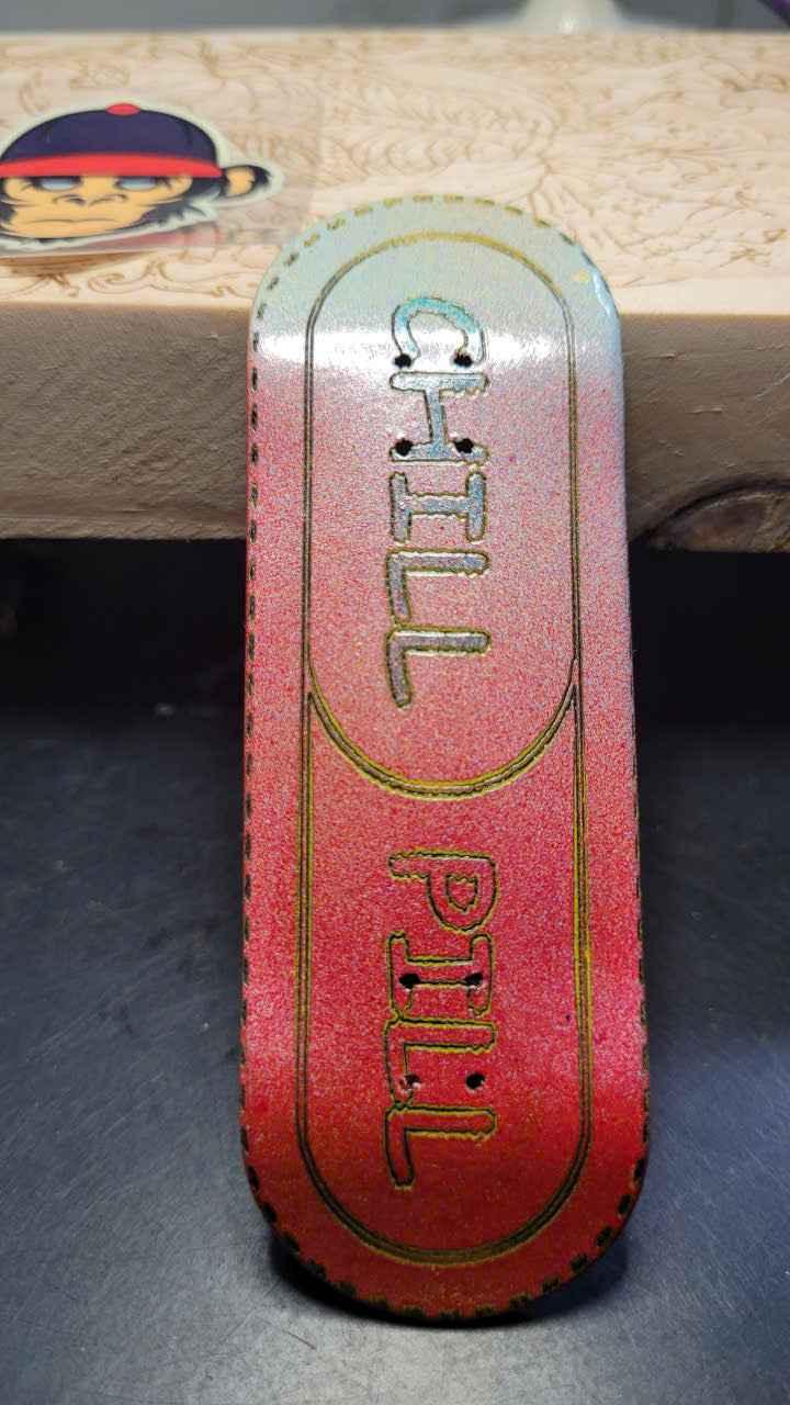 Custom fingerboard griptape with a red and blue gradient and 'CHILL PILL' text.