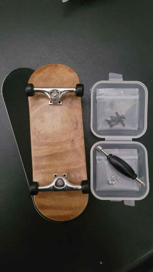 Custom handmade wooden fingerboard deck with silver trucks, wheels, and assembly tools.