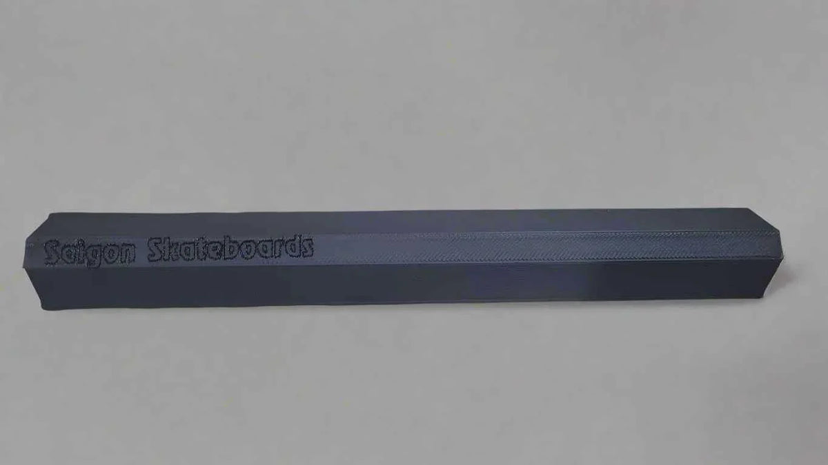 Saigon Skateboards branded black fingerboard rail for technical tricks.