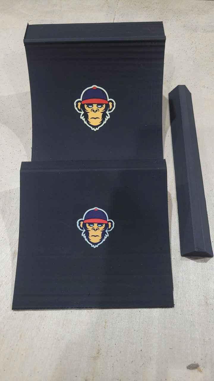 Two black fingerboard training ramps and a rail featuring a monkey logo.