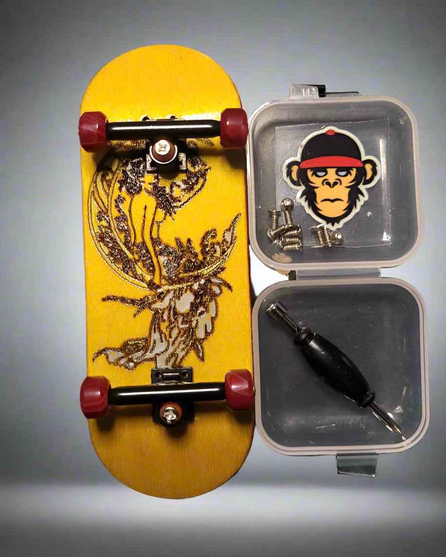 Custom yellow fingerboard with graphic art, mini trucks, wheels, and assembly tools in a case.