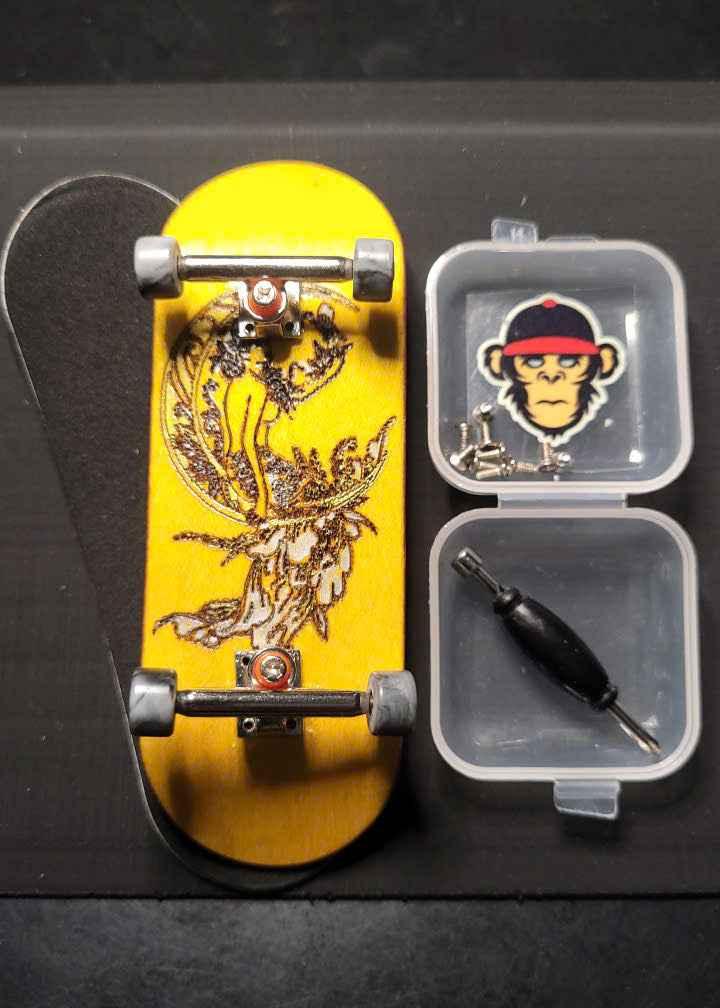 Custom yellow fingerboard deck with graphic, silver trucks, and mini tool kit.