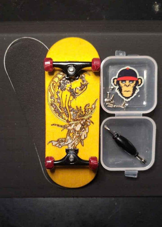 Custom yellow fingerboard deck with graphic art, mini trucks, wheels, and assembly tools.