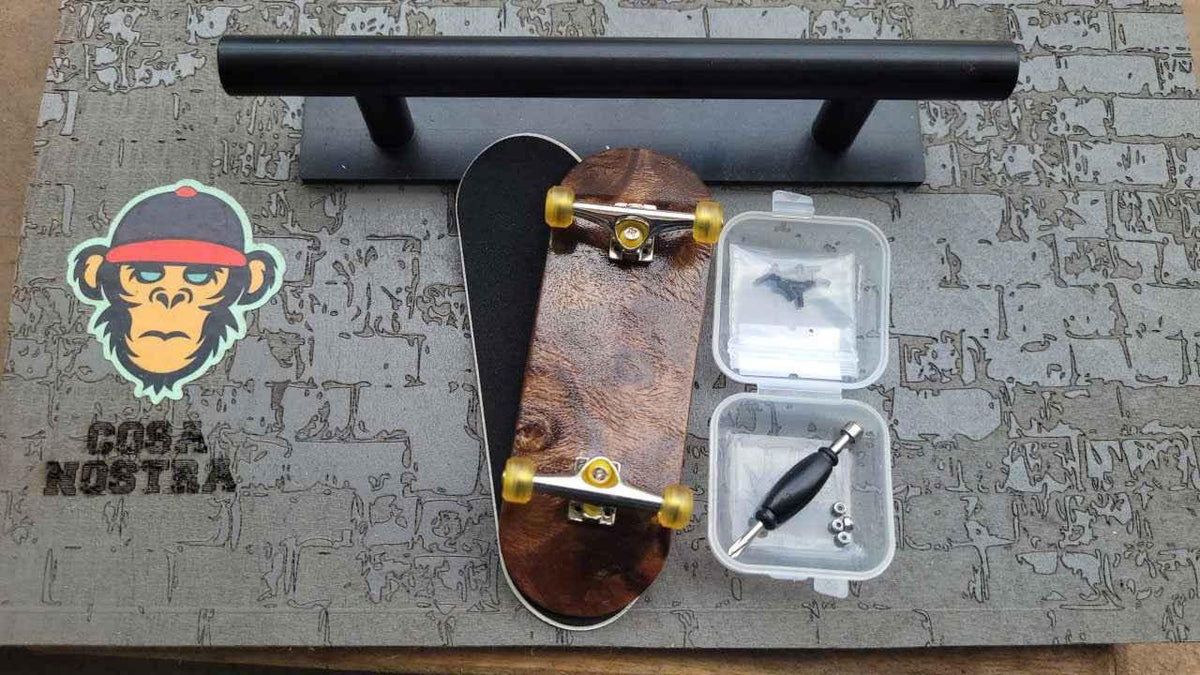 Custom handmade wooden fingerboard deck with trucks, wheels, and assembly tools.