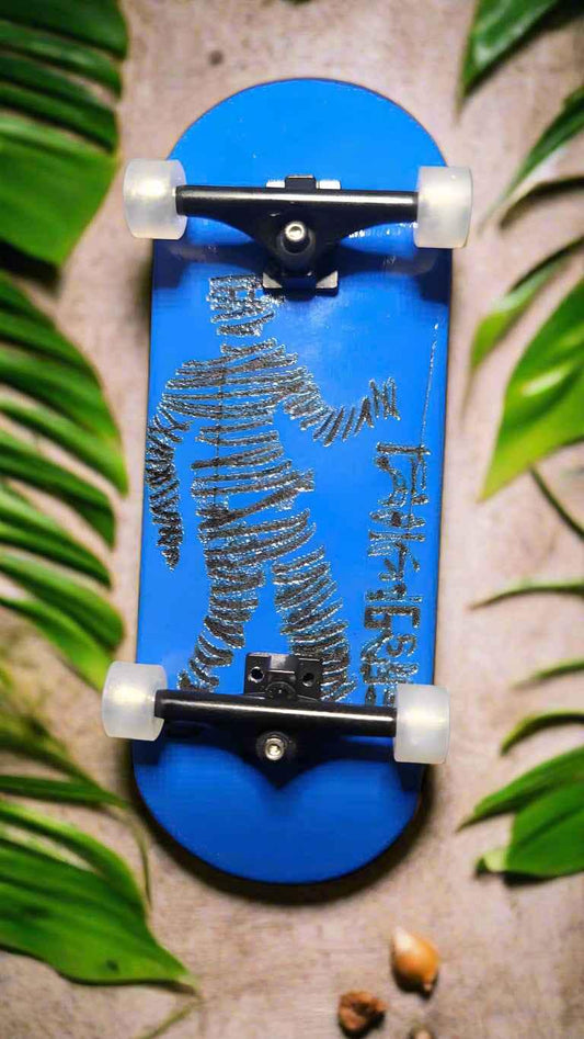 Blue custom fingerboard deck with a black graphic illustration on a tropical leaf background.