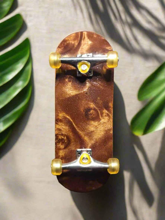 Handmade custom wooden fingerboard deck with yellow wheels and silver trucks.