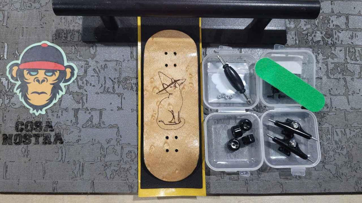 Custom handmade wooden fingerboard deck with cat graphic and fingerboard accessories.