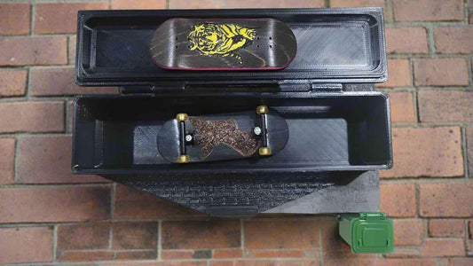Custom handmade fingerboard deck with tiger graphic in a black storage box.