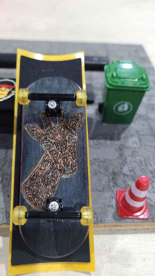 Custom handmade fingerboard deck featuring a detailed giraffe graphic and yellow wheels.