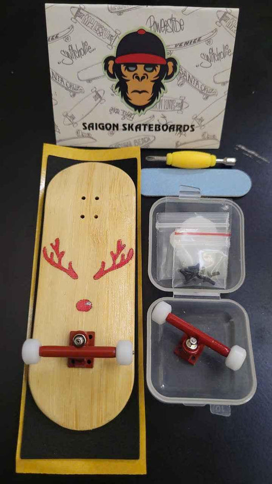 Custom handmade wooden fingerboard deck with reindeer design, red trucks, and accessories.