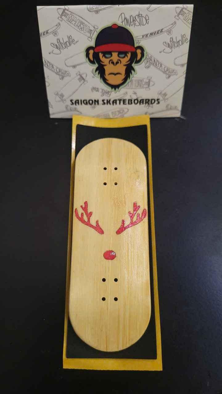 Handmade wooden fingerboard deck with red reindeer graphic design.