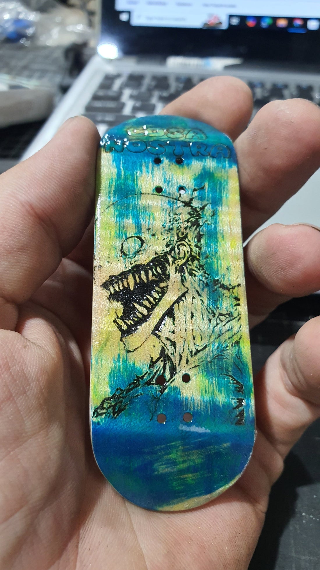 Handcrafted relic fingerboard deck by Saigon Skateboards showing intentional distressing and aged wood finish