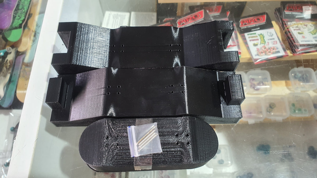 Black custom mold tray with central cavity and round end pieces