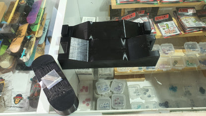Black 3D-printed mold with open grid center and rounded side piece