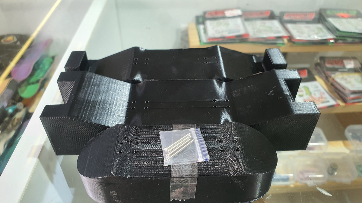 Black custom mold with central cavity and curved front roller