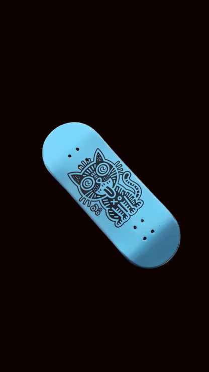 Skateboard fingerboard deck, angled blue top with cat line art and grip holes
