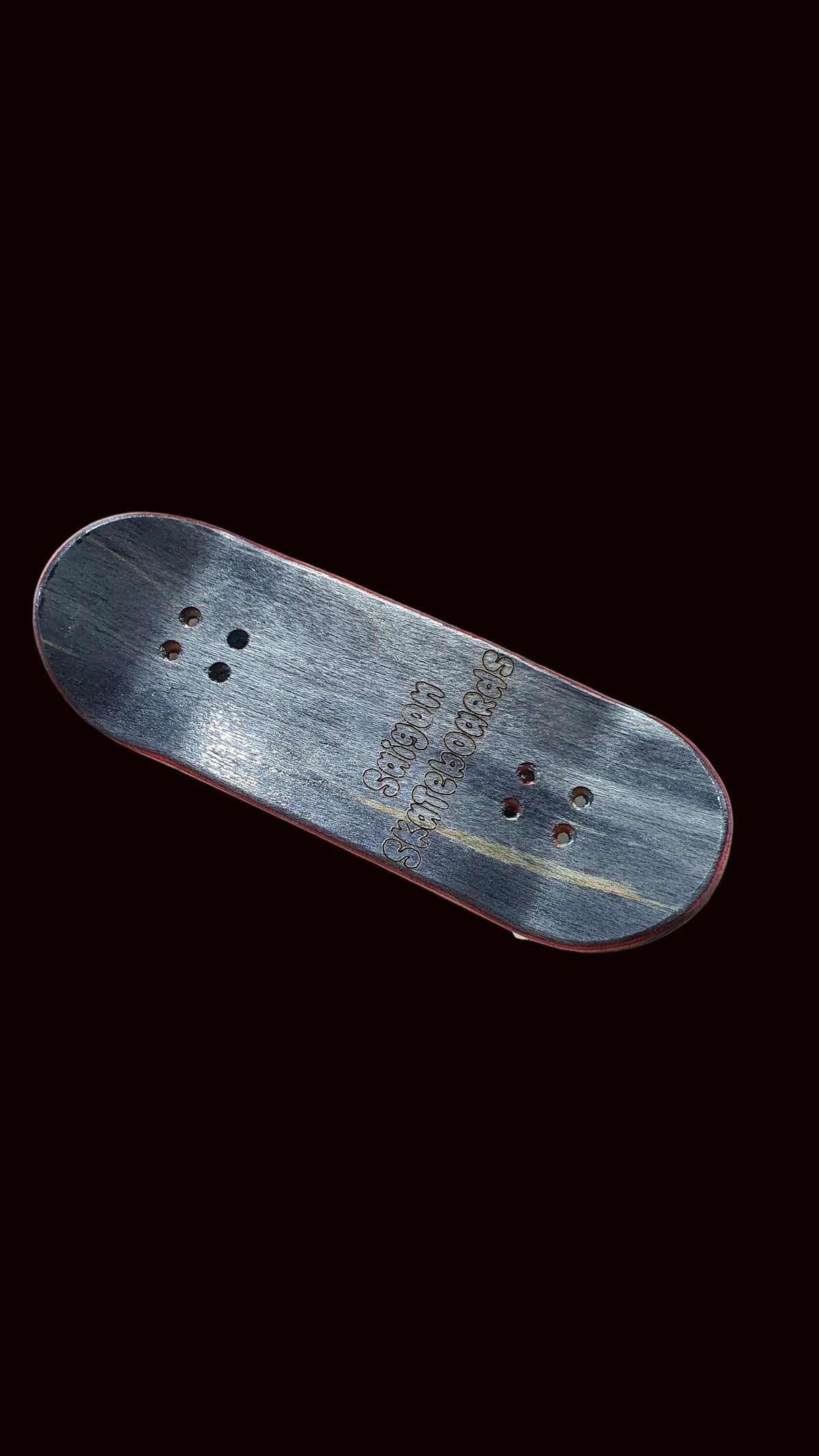 Skateboard fingerboard deck, angled gray top with cat graphic and grip holes