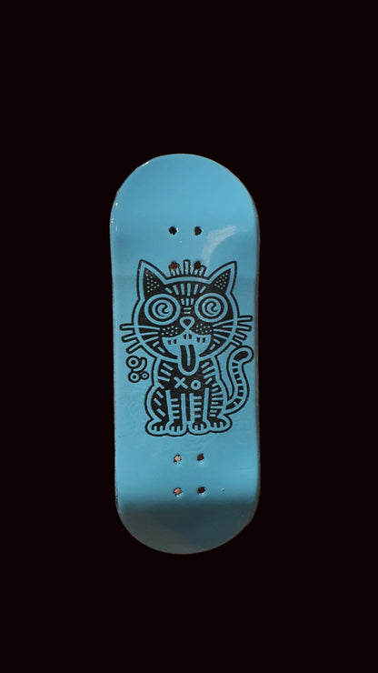 Skateboard fingerboard deck, blue top with cat graphic and grip holes