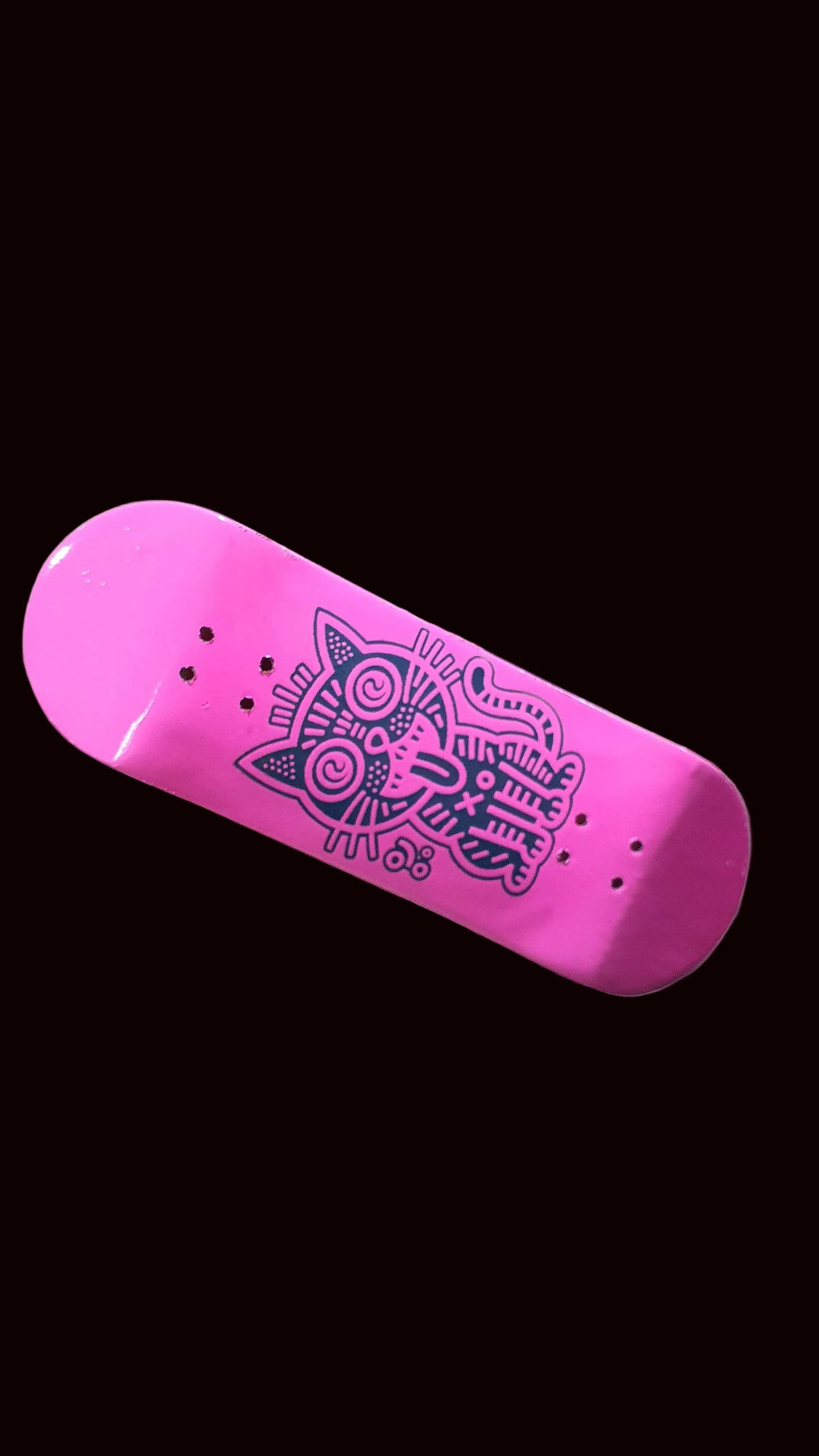 Pink fingerboard deck with purple cat graphic and three bolt holes