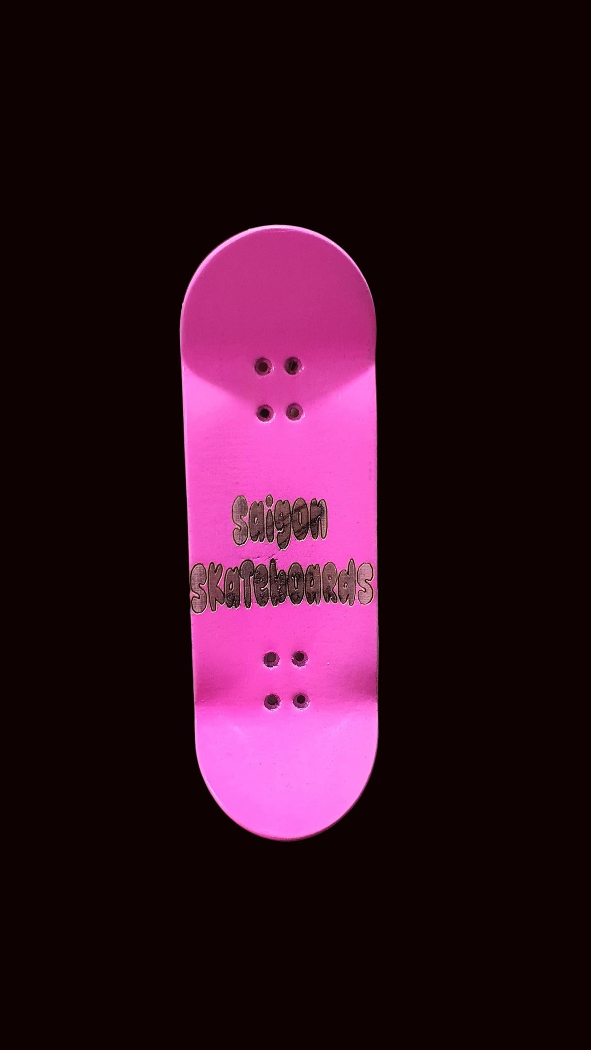 Pink fingerboard deck with dark logo text and multiple bolt holes