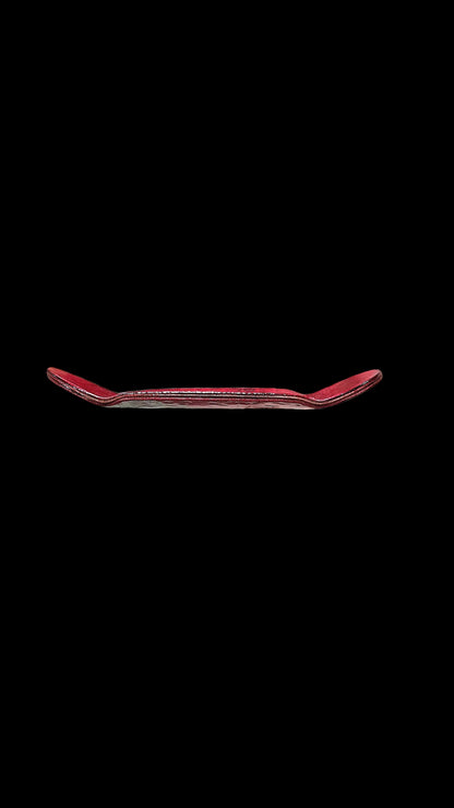 Red fingerboard deck underside view showing concave curve and edges.