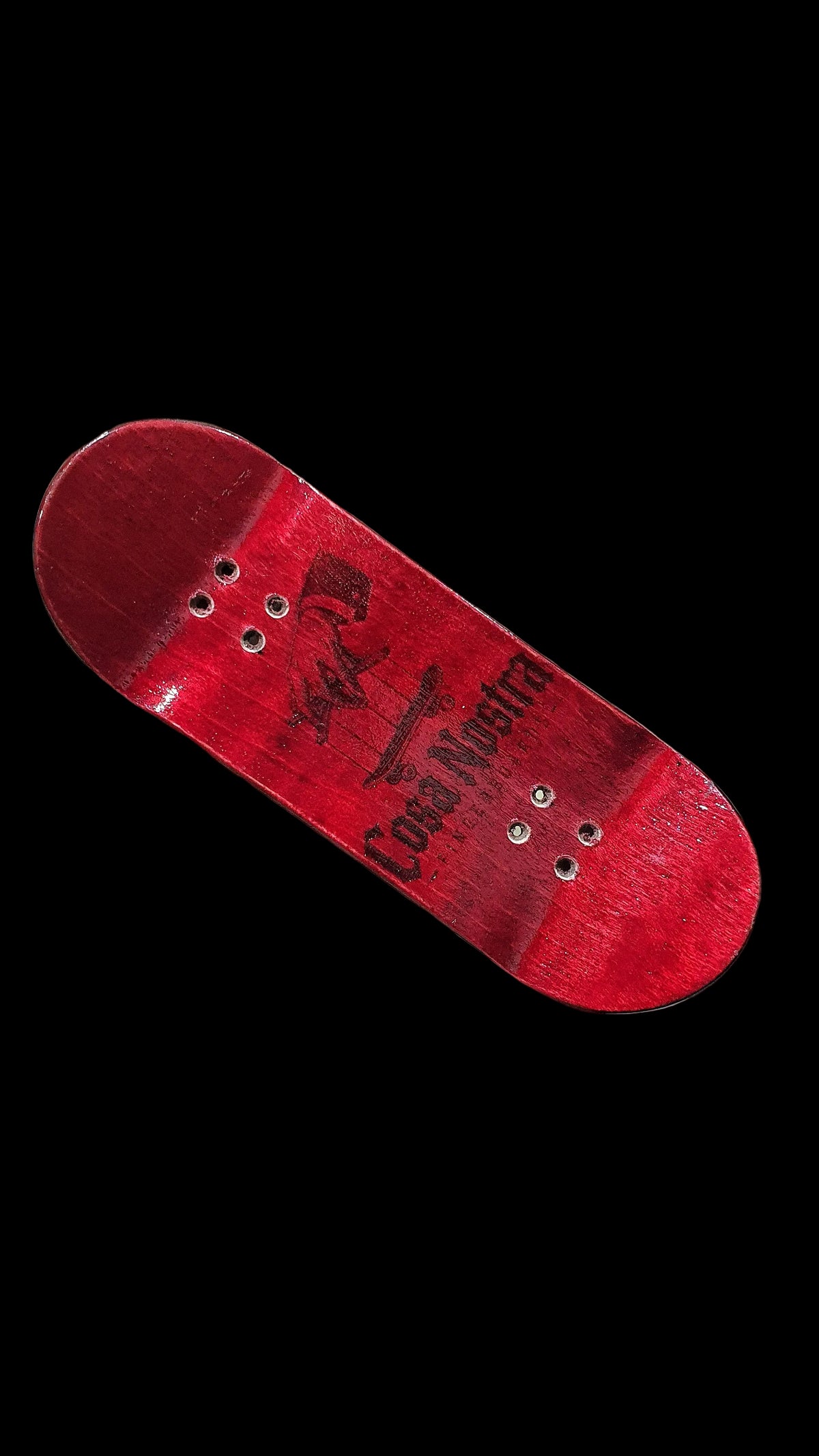 Red fingerboard deck top detail with graphic logo and four mounting holes.