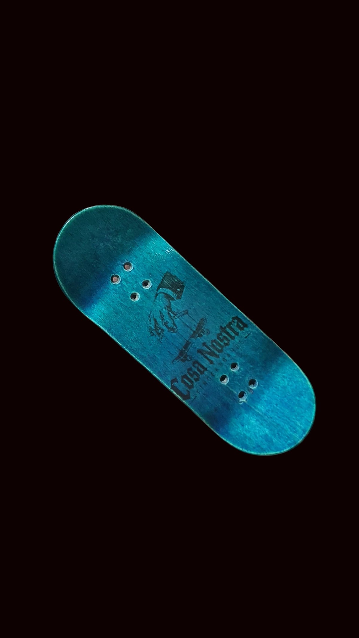 Blue teal fingerboard deck, angled view with centered graphic and mounting holes.