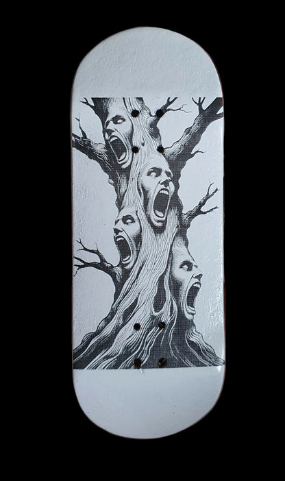 Skateboard deck with white base and black tree-screaming face graphic