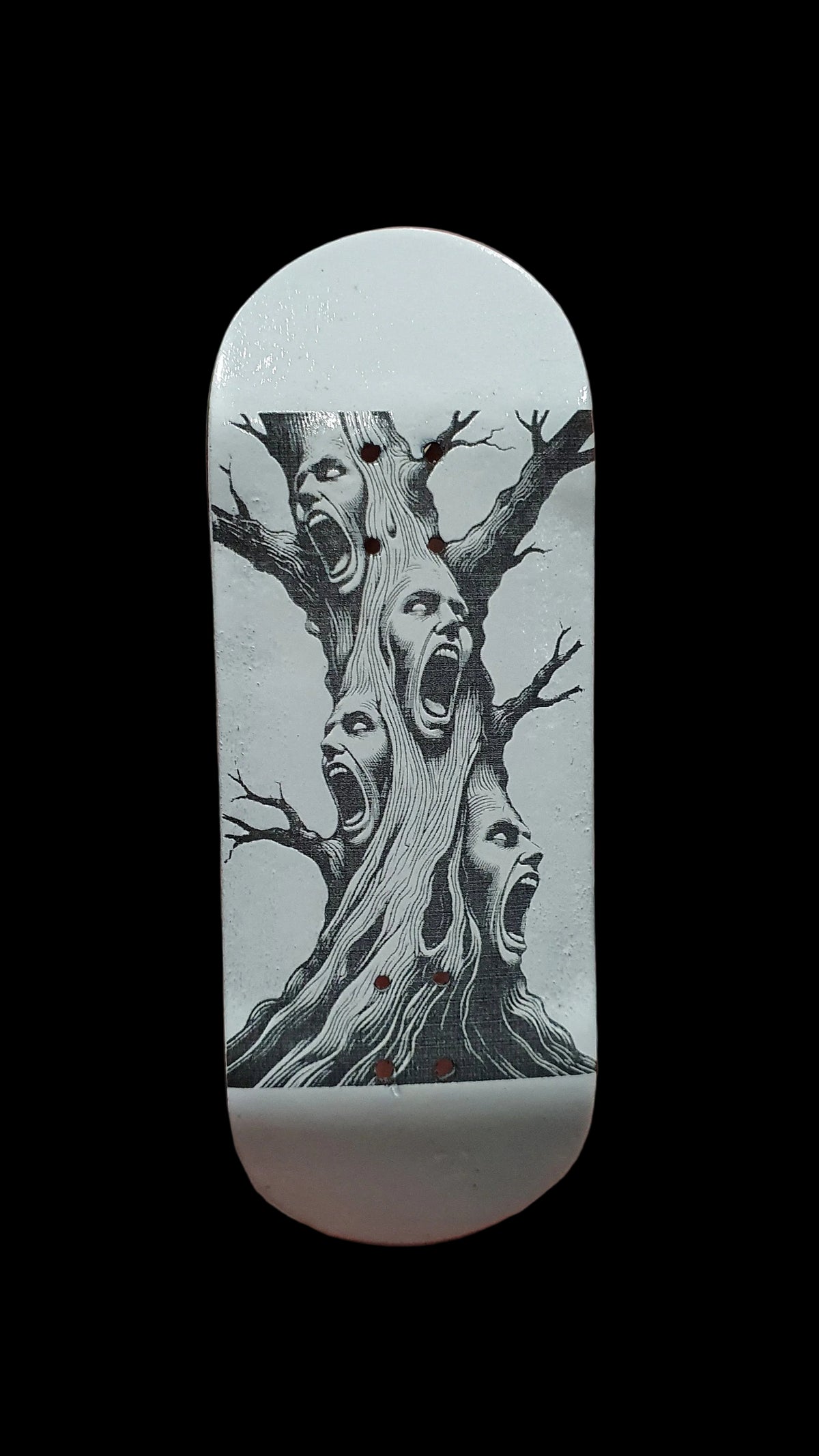 Skateboard deck with centered tree-face illustration in black on light base