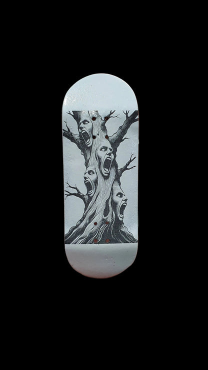 Skateboard deck with tall tree-face illustration in black on white base