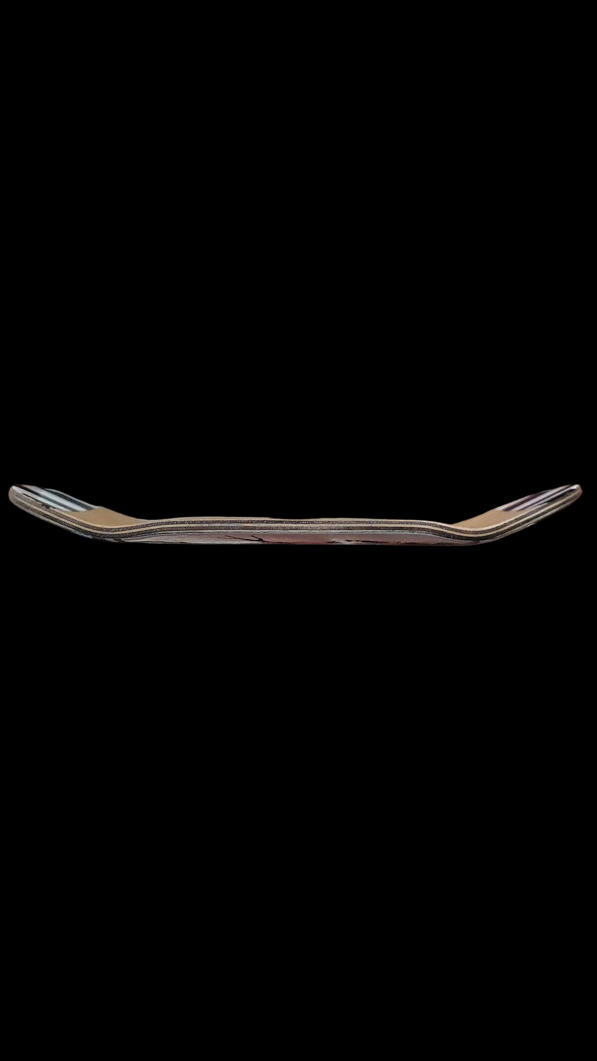 Skateboard deck side profile view with layered wood edge