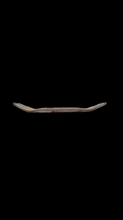 Skateboard deck side view showing curved profile and layered wood layers