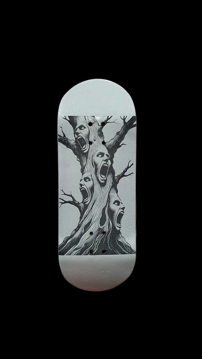 Light gray skateboard deck with black-and-white tree showing screaming faces graphic