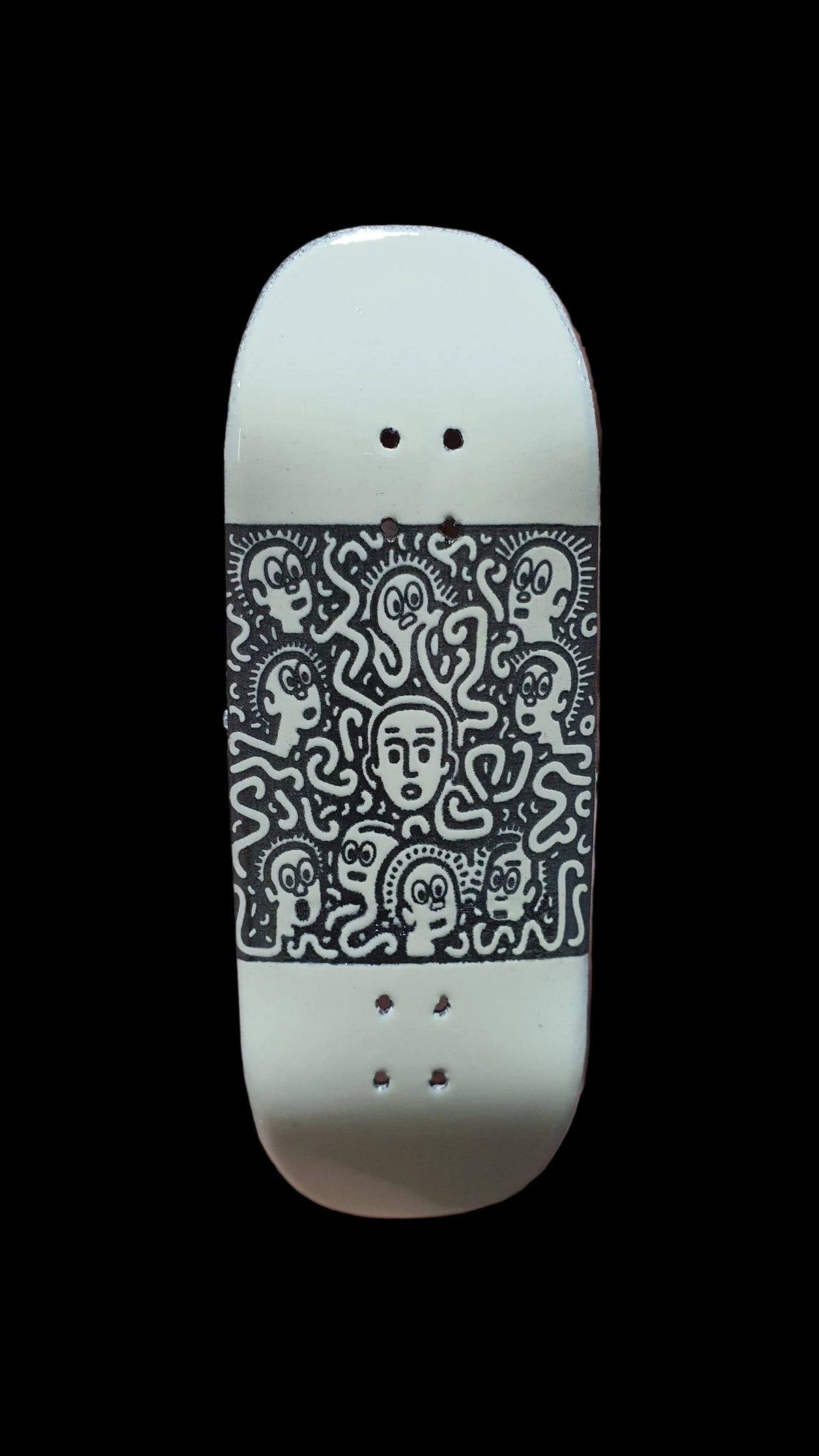 Saigon Skateboards Confusion fingerboard deck, showing a dense black character pattern on white