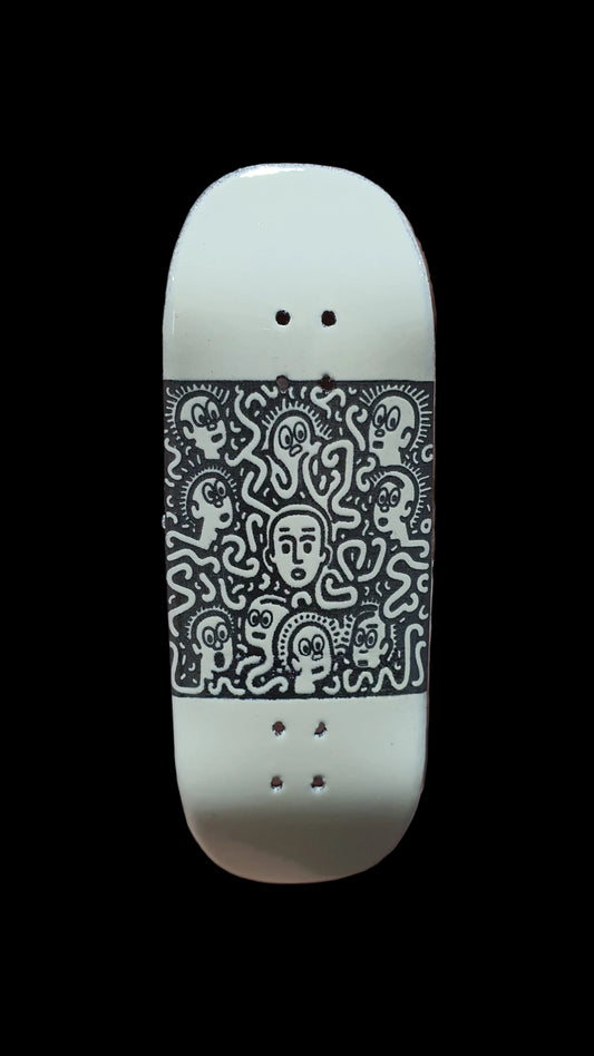 Saigon Skateboards Confusion fingerboard deck, showing a dense black character pattern on white