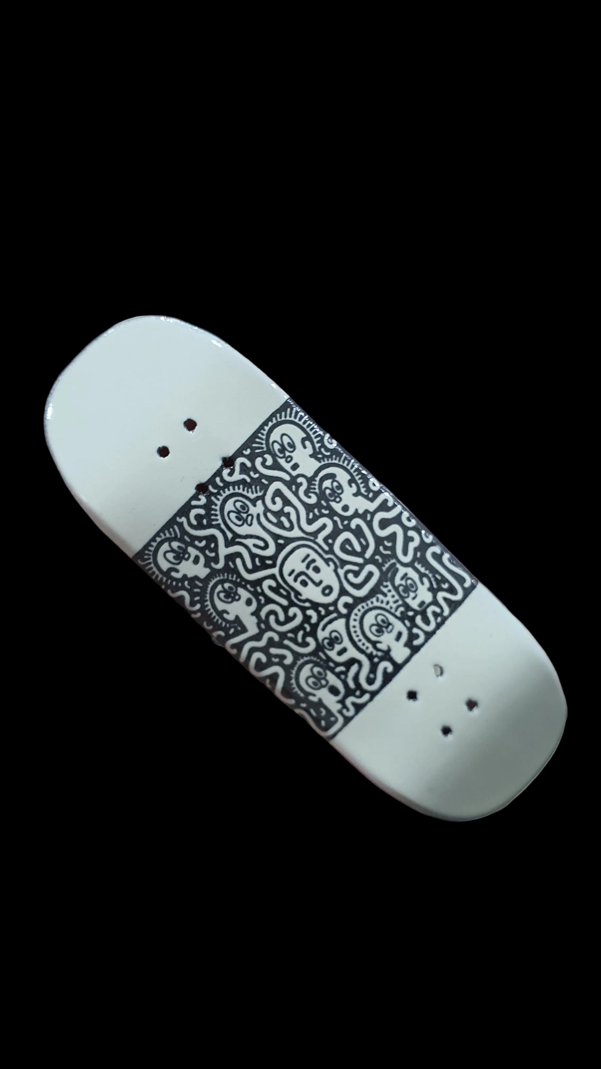 Confusion fingerboard deck with black-and-white graphic panel and four mounting holes