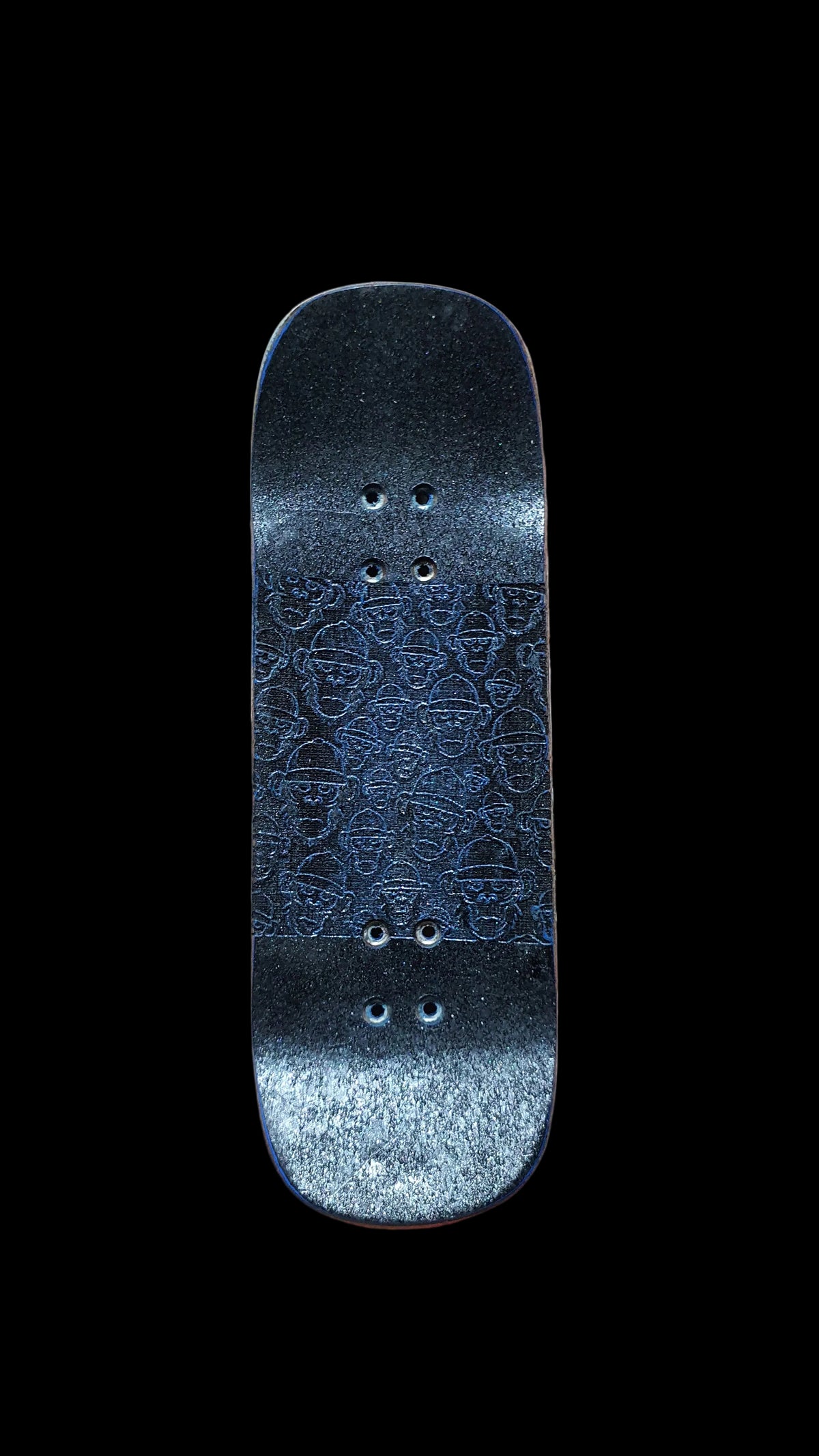 Fingerboard deck top with blue patterned grip, rounded ends, and mounting holes