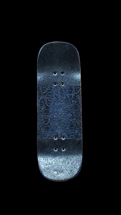 Fingerboard deck top with blue patterned grip, rounded ends, and mounting holes