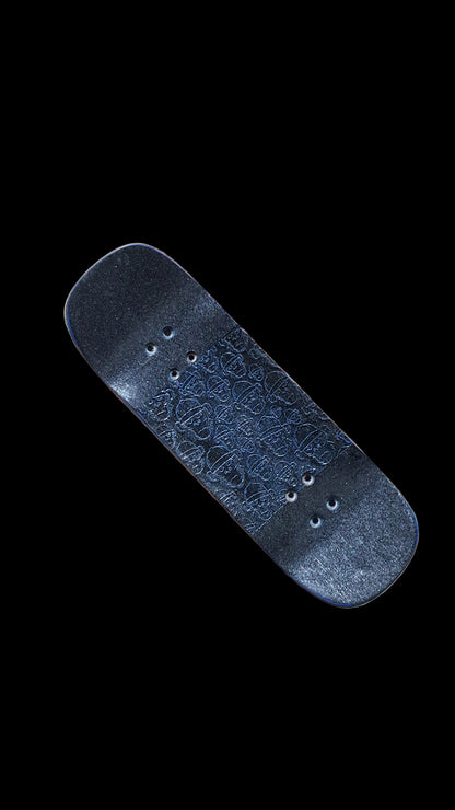Angled view of the fingerboard deck top with blue patterned grip and mounting holes