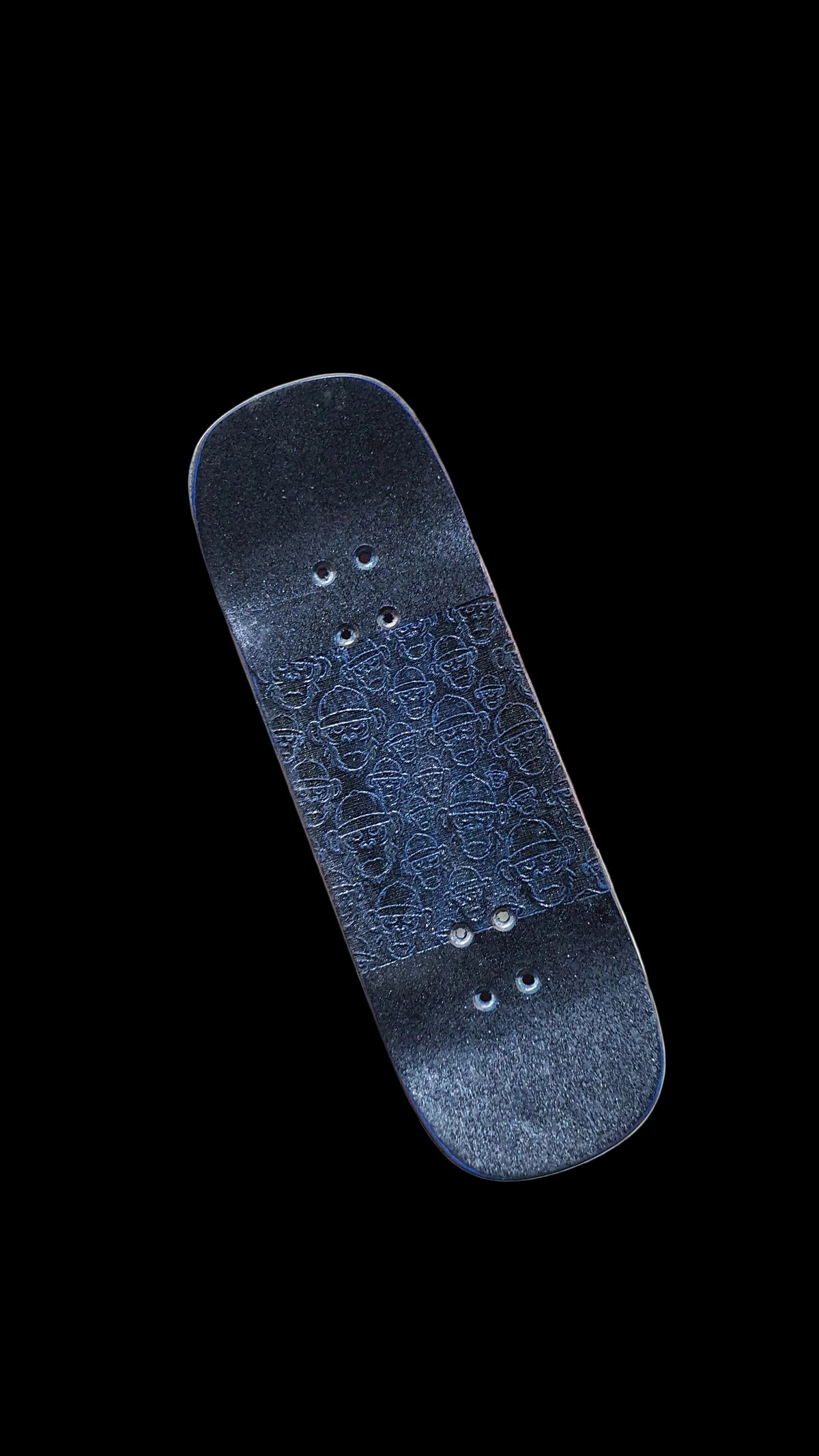 Angled underside of Cosa Nostra fingerboard deck with patterned dark grip and mounting holes