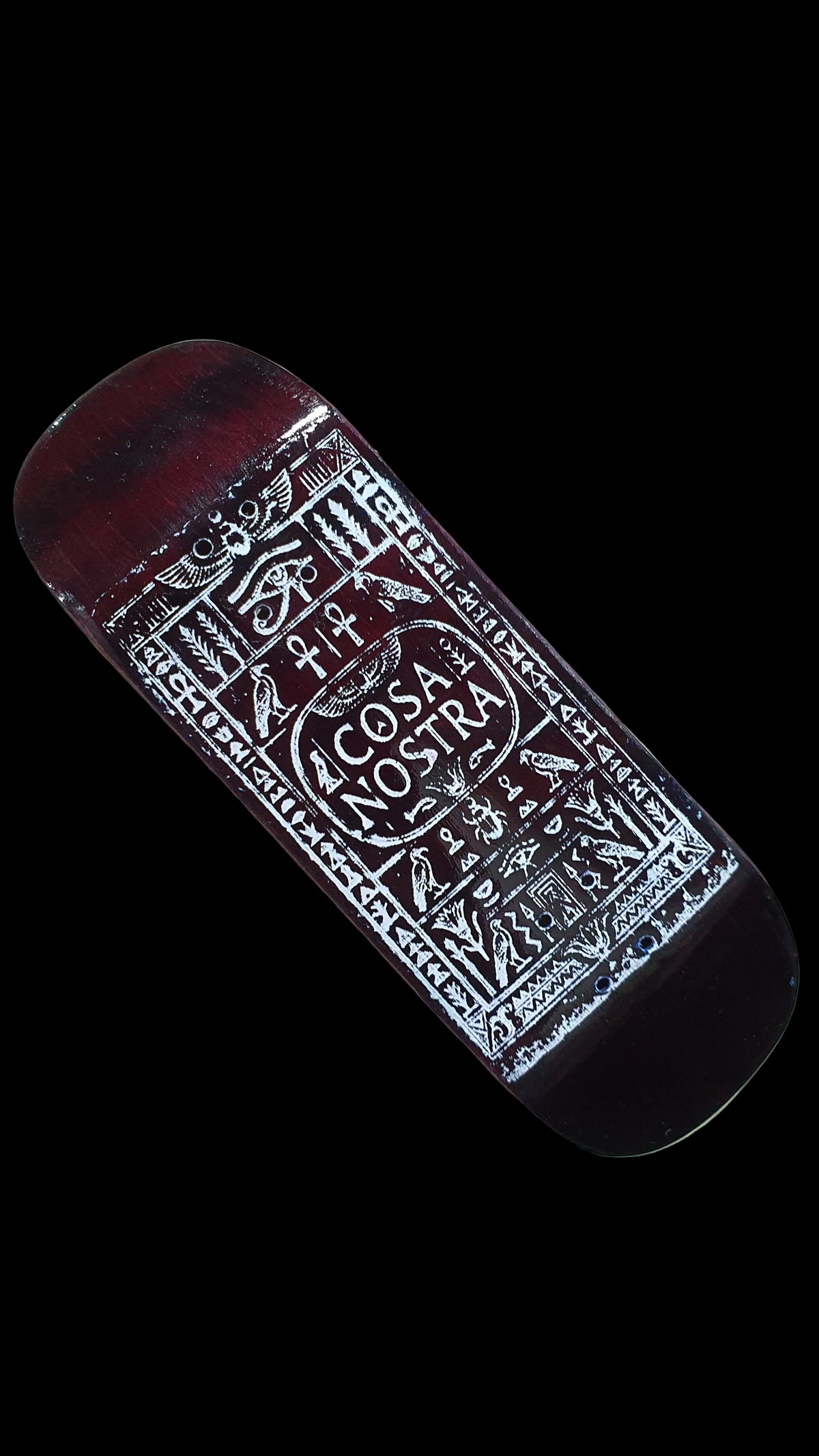 Angled view of the fingerboard deck's red-brown underside and white Cosa Nostra graphic