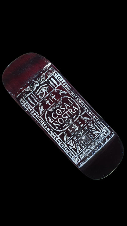 Angled view of the fingerboard deck's red-brown underside and white Cosa Nostra graphic