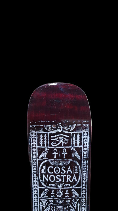 Close-up of the red-brown fingerboard underside with ornate white Cosa Nostra graphic