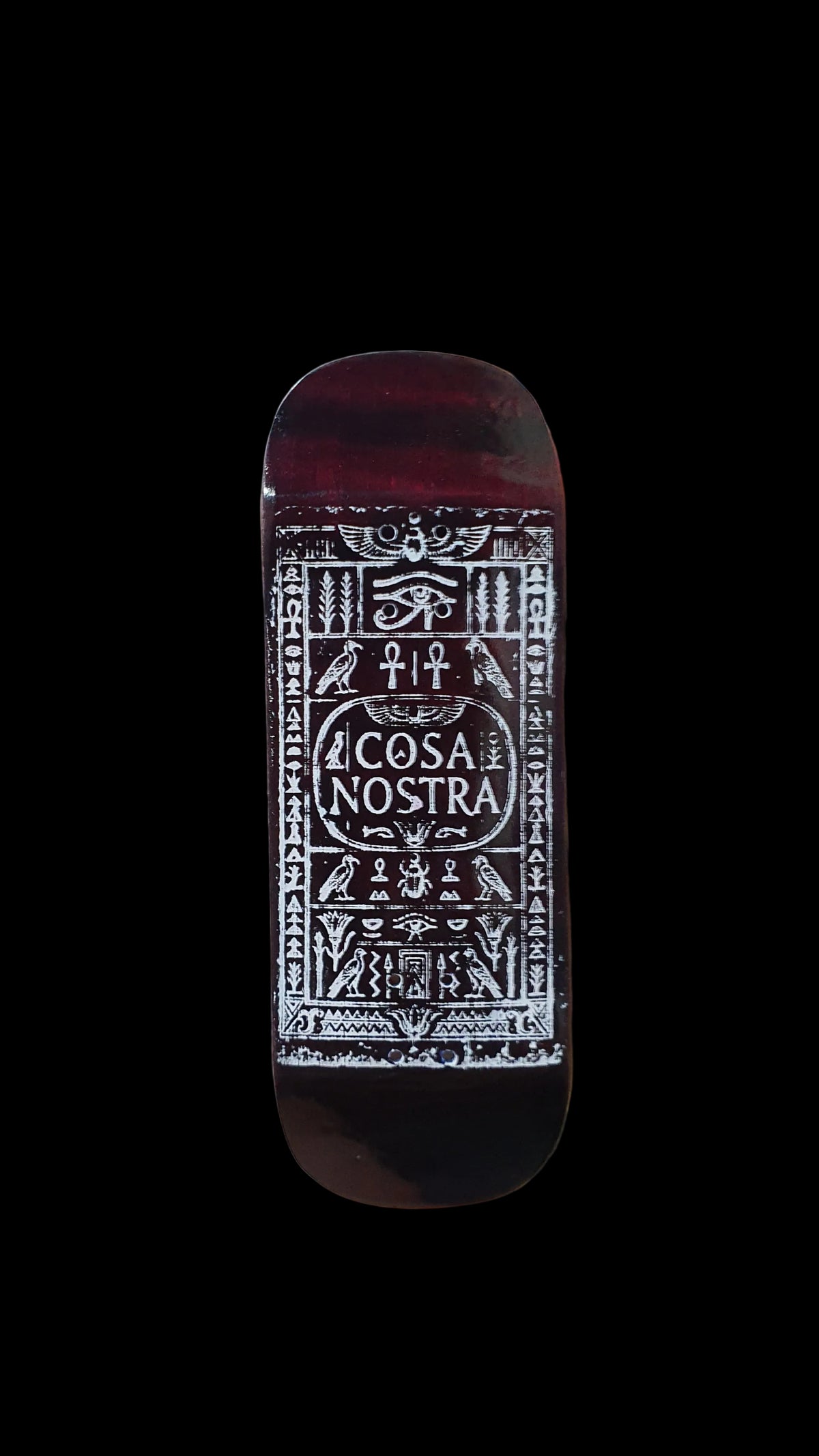 Cosa Nostra fingerboard deck with ornate white graphic on a dark red-brown surface