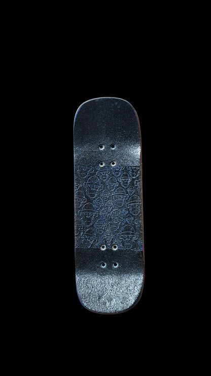 Fingerboard deck underside with dark patterned grip and four pairs of mounting holes