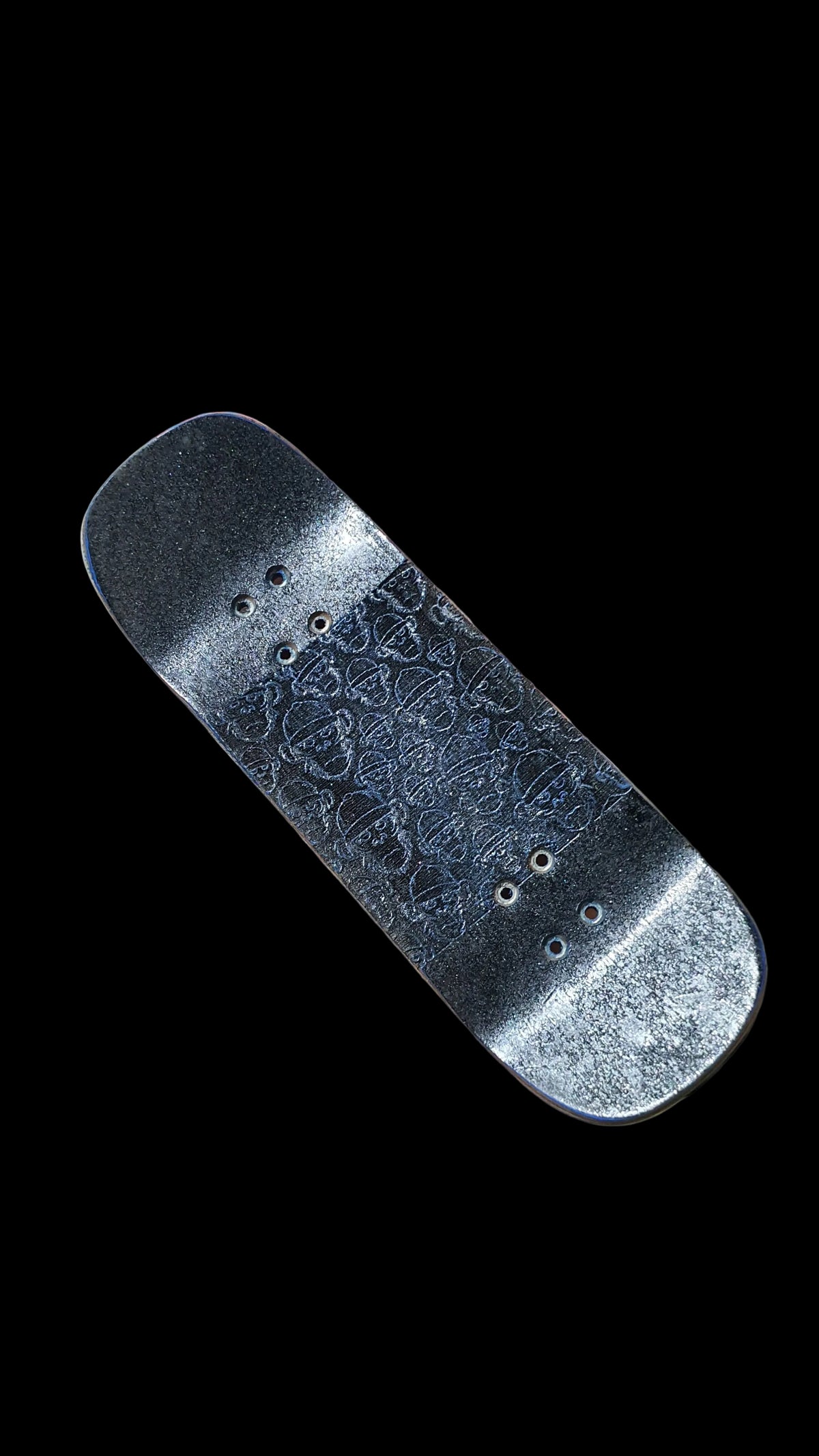 Angled Cosa Nostra fingerboard deck underside showing textured grip and mounting holes