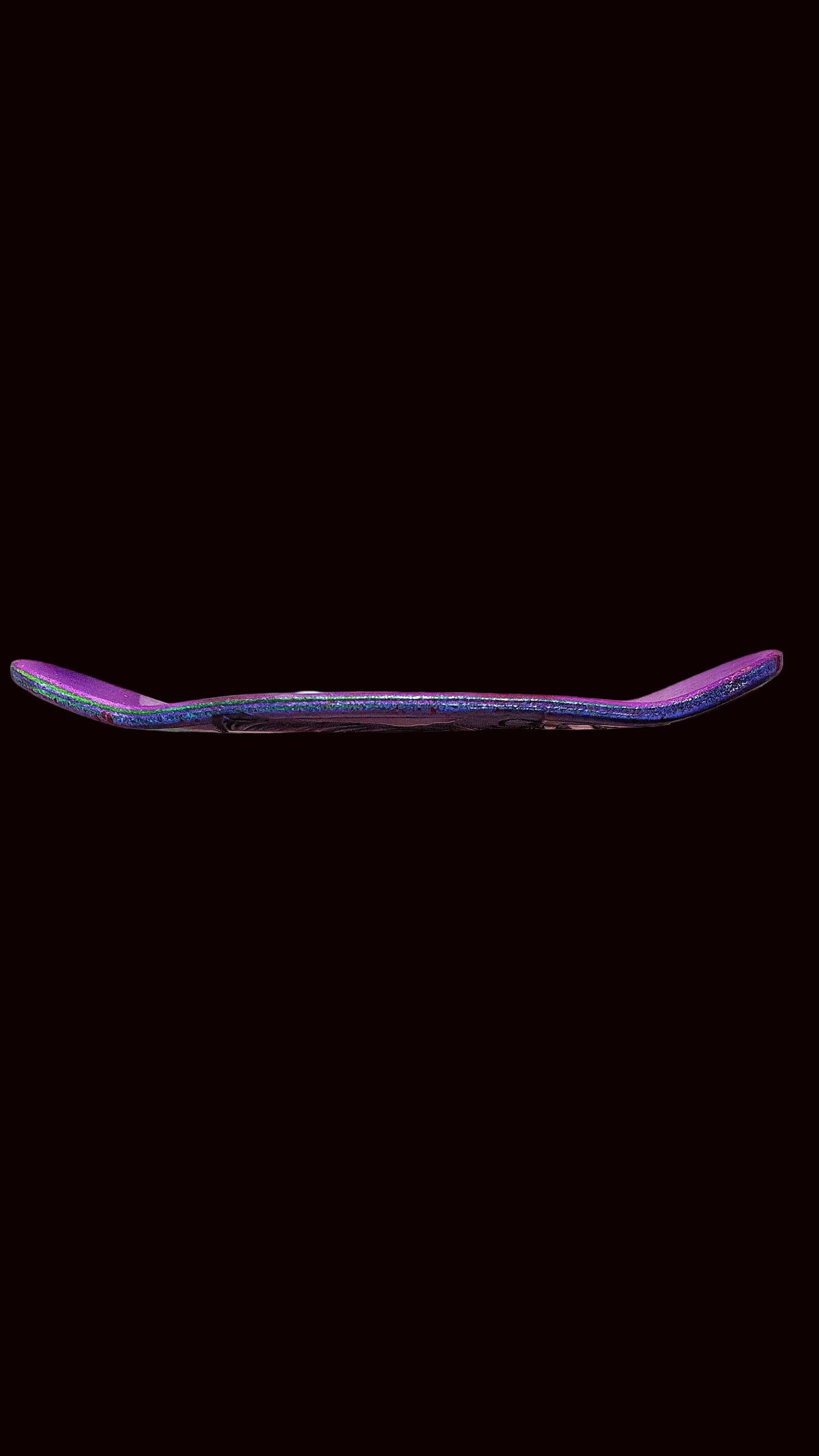 Purple fingerboard deck side profile with colorful speckle and clean edges.