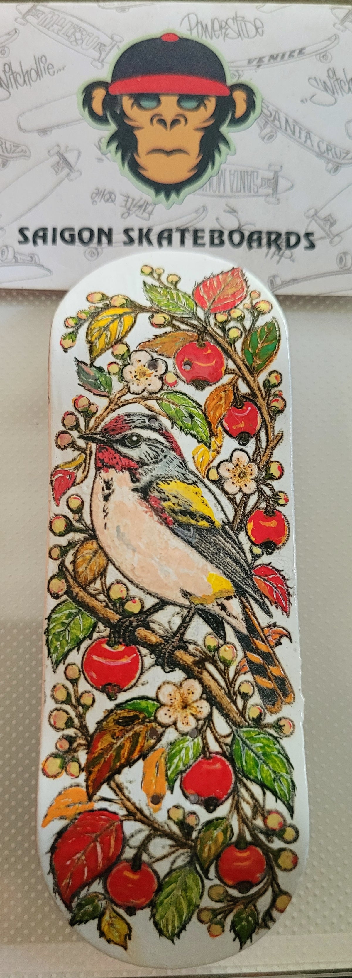 Bird graphic fingerboard deck with colorful floral and cherry design