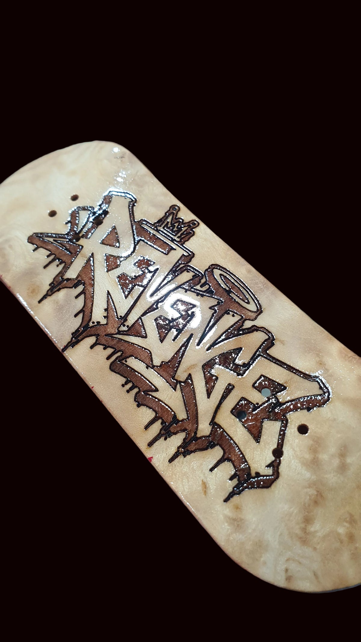 Canadian maple fingerboard deck with light wood finish and graffiti-style Revenge graphic